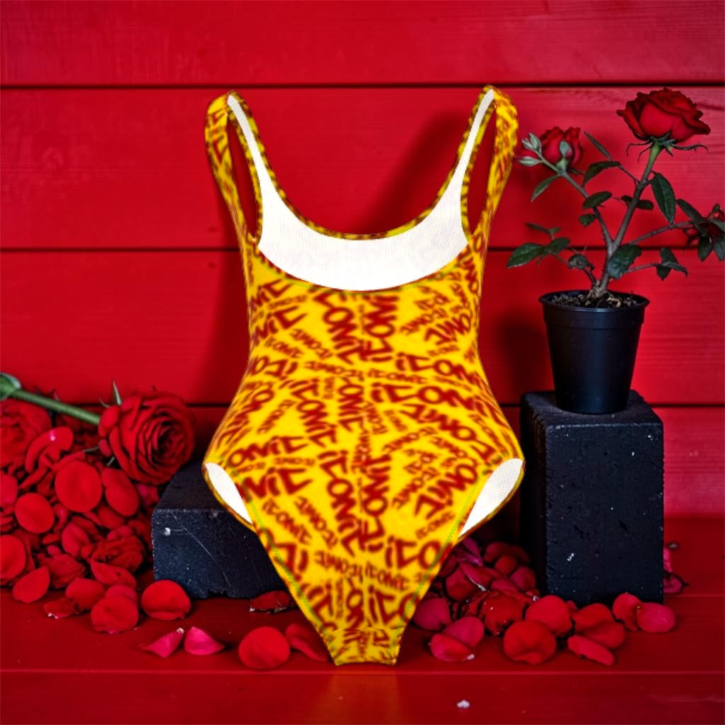 Image 3 — Back view (scarlet red wall, rose petals): Golden Expression Art Vol IV The ICONIC One-Piece — back view showing golden yellow all-over ICONIC print, white contrast lining at neckline, scarlet red wall with rose petals