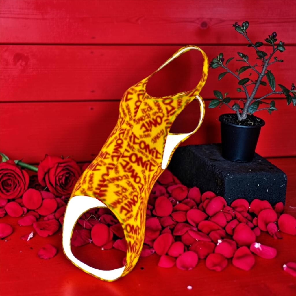 Image 4 — Side/angled editorial (scarlet red wall, rose petals): Golden Expression Art Vol IV The ICONIC One-Piece — side angle editorial view of golden yellow ICONIC print Lycra one-piece, scarlet red wall backdrop, rose petal floor — ICONIC Edit