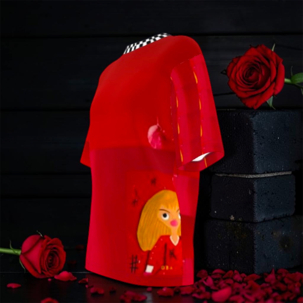 Image 2 — Side/angled view (roses, dark backdrop): Golden Expression Art Vol IV The Scarlet Rule Tee — side angle view showing scarlet red body, checkered neckline, and Doll Wall figure graphic, styled with red roses