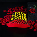 Vol IV — The Two-Sided Crown Reversible Bucket Hat, side view, yellow & black checkered top with red & black checkered brim, rose petal editorial — Golden Expression Art