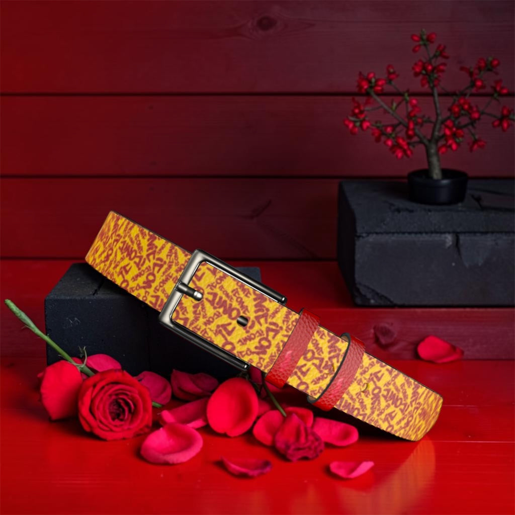 The Golden Decree Belt — golden yellow with scarlet red ICONIC lettering, gunmetal buckle, rose petal editorial