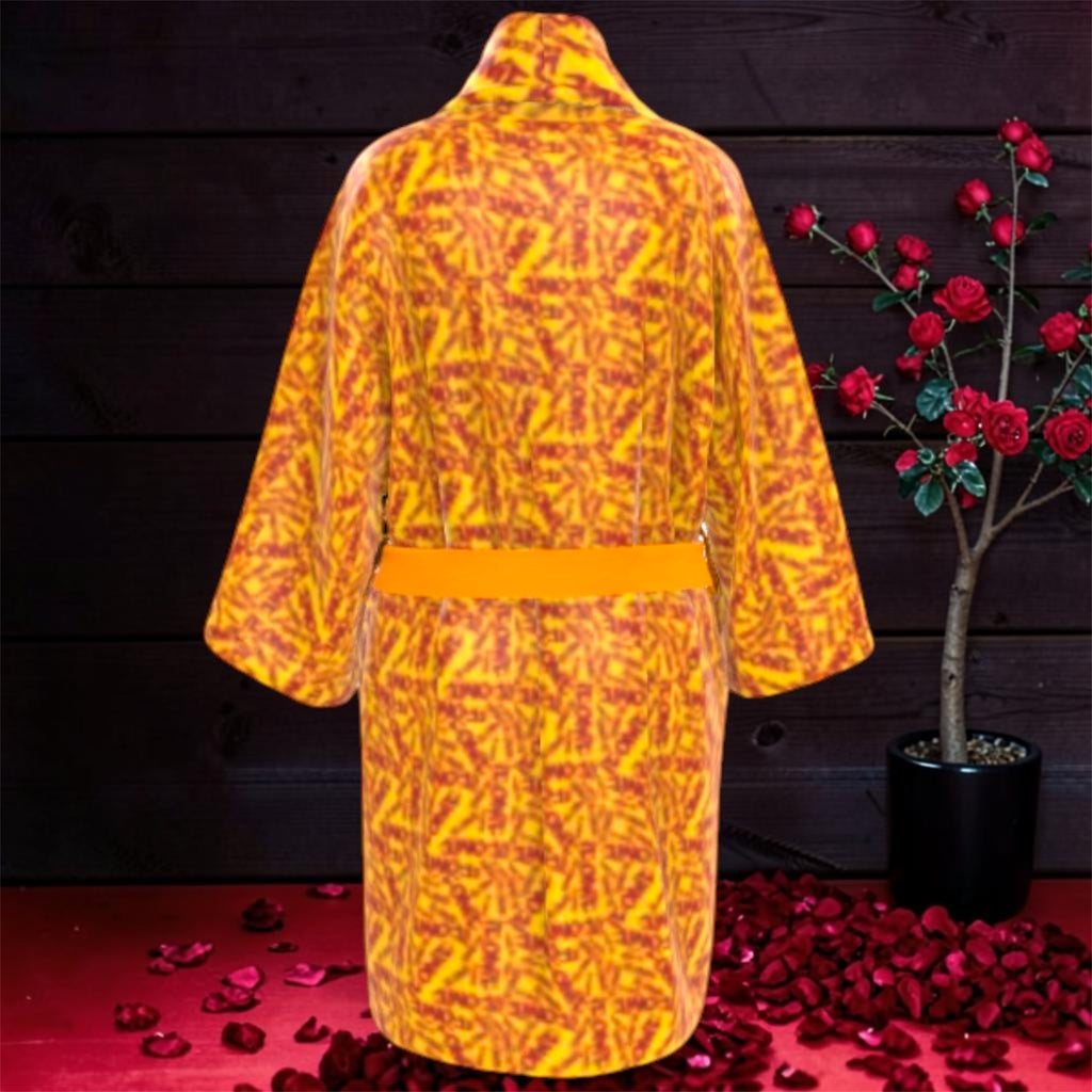 The Decree Kimono Wrap — back view, full ICONIC print, golden trim, rose editorial backdrop