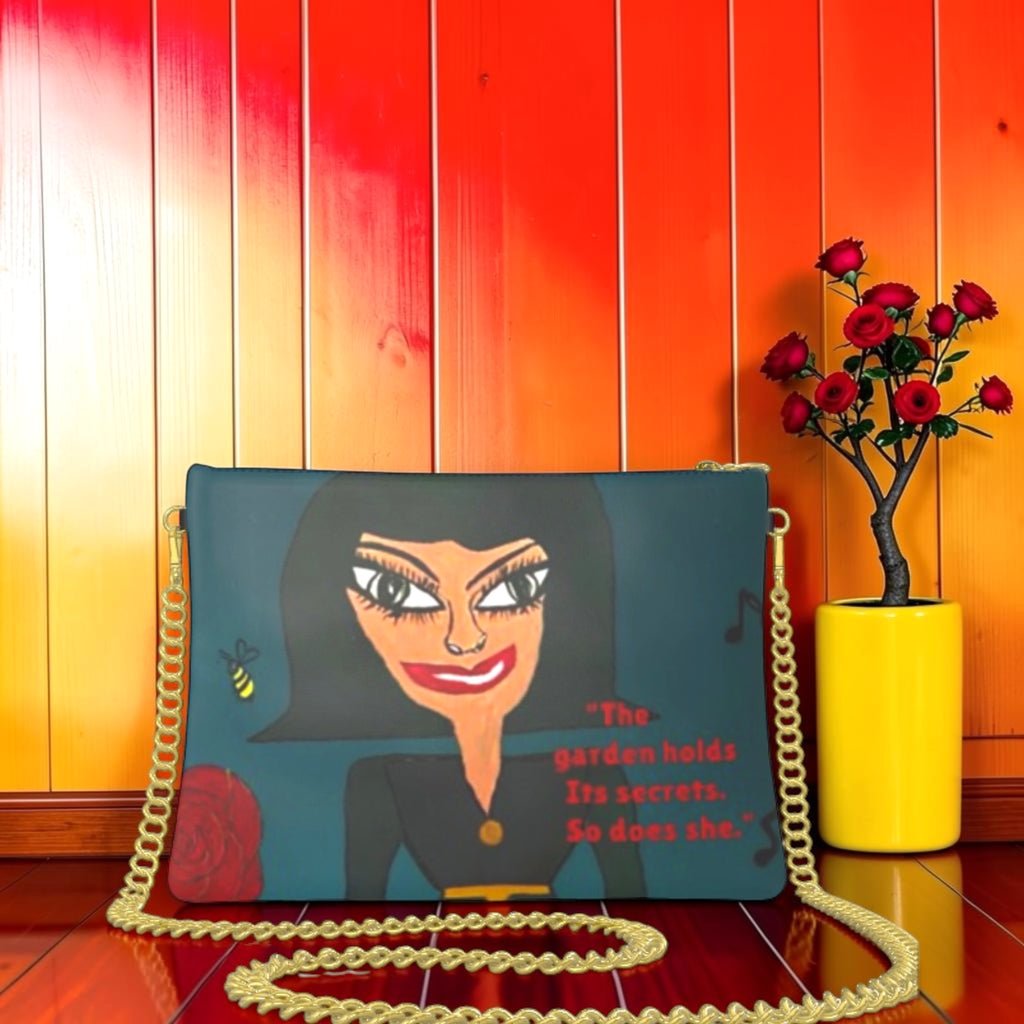Vol II The Eden Secret Clutch — back view, Doll Wall figure on teal body with signature quote The garden holds its secrets So does she, GEA Vol II