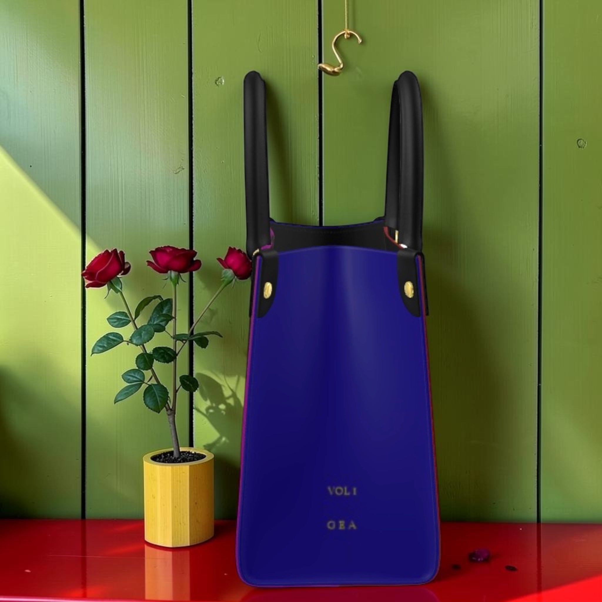 Vol I — The Doll Wall Lady Bag, side view hanging, royal blue exterior, purple trim edge, VOL I GEA gold emboss, black straps, GEA