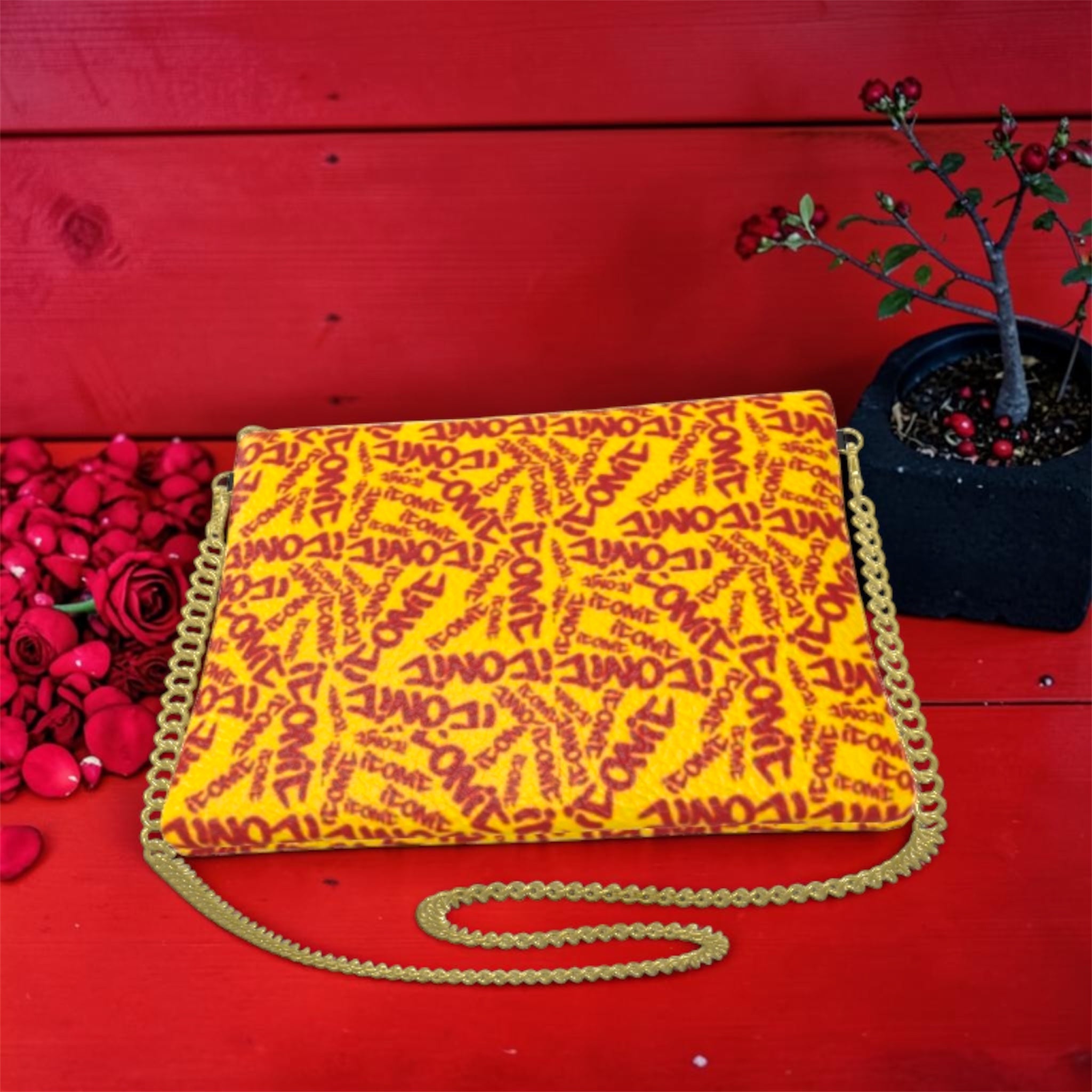 The ICONIC Soirée — back view, ICONIC all-over print bubble leather clutch with gold chain strap, red wall and rose petal styling