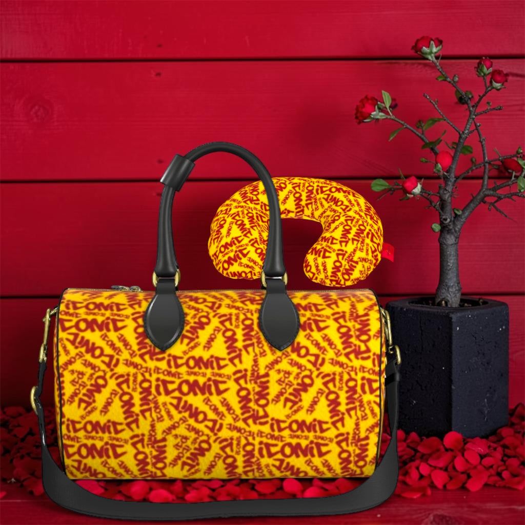 The ICONIC Carry Duffel Set — golden yellow ICONIC all-over print duffel with matching neck pillow, black handles and gold hardware, rose petal editorial backdrop