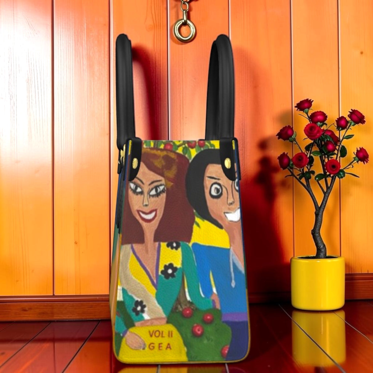The Eden Garden Satchel — Vol II GEA — standing view showing Doll Wall figures and Vol II GEA branding on Nappa pebble leather