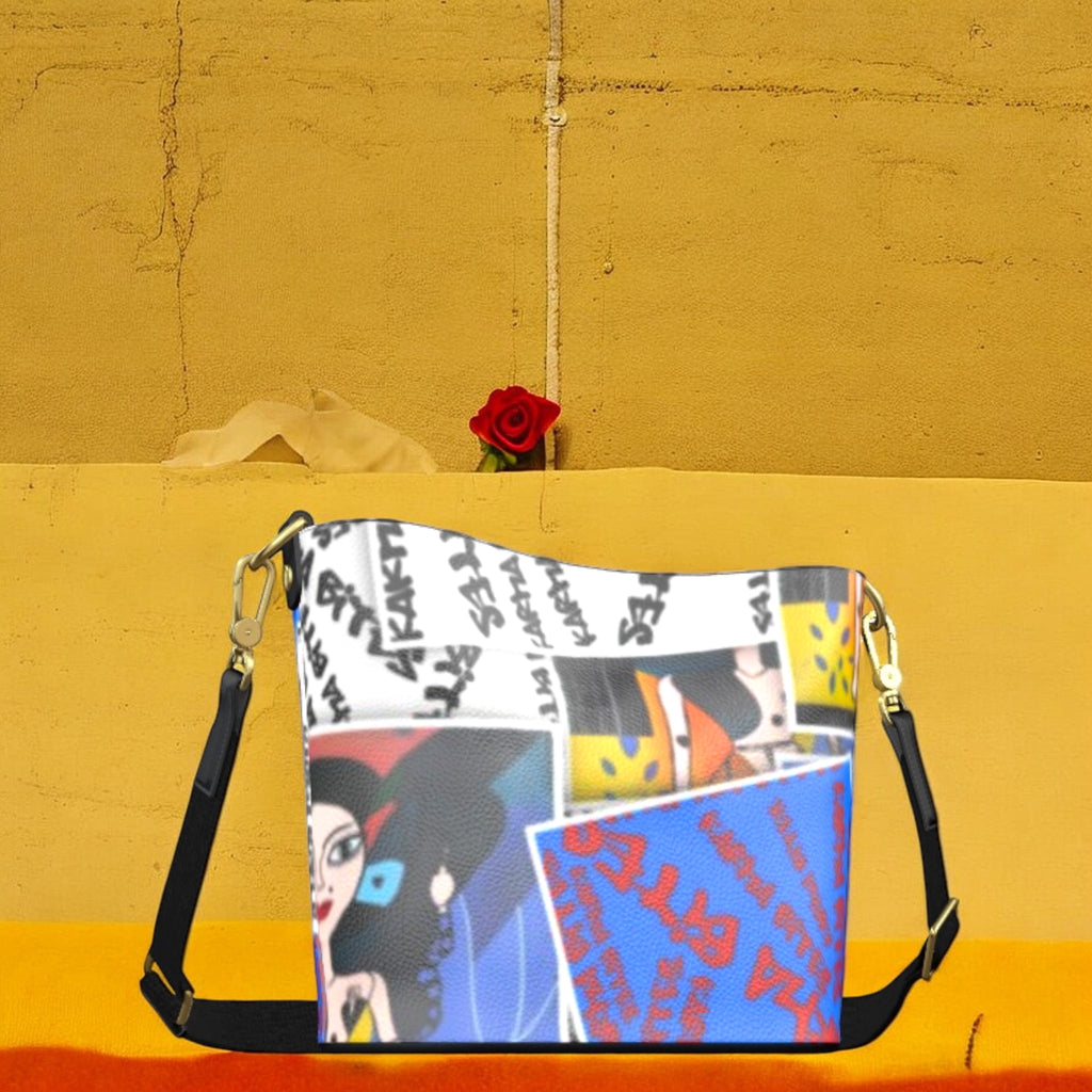 Golden Expression Art Vol III Karma Bites Bucket Bag — front view, Doll Wall collage panel with Karma Bites graffiti script and cerulean blue color-block detail, gold-tone hardware
