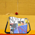Golden Expression Art Vol III Karma Bites Bucket Bag — front view, Doll Wall collage panel with Karma Bites graffiti script and cerulean blue color-block detail, gold-tone hardware
