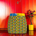 Vol II Queen of Eden Mini Skirt front — all-over Doll Wall Eden lady repeat print with sky blue and golden yellow panels
