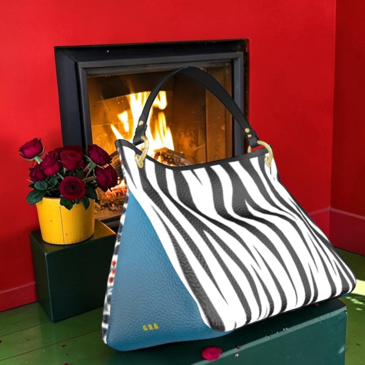The Blue Bloom Shoulder Bag with zebra-print front, blue side panel, black shoulder strap and gold-tone hardware