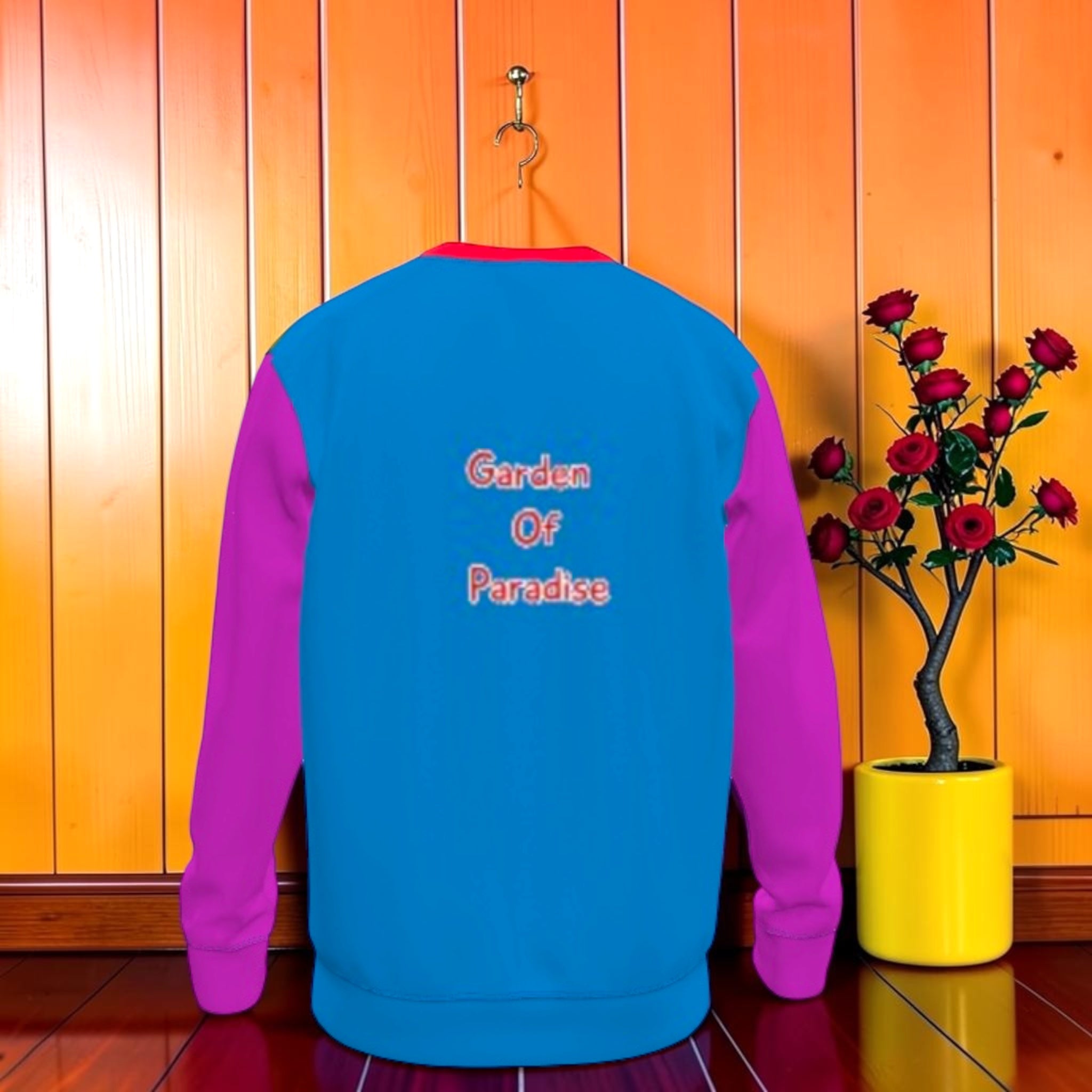 Vol II — The Garden of Paradise Sweatshirt, back view, solid sky blue body, Garden Of Paradise text center back, magenta fuchsia sleeves, red ribbed collar and hem, GEA