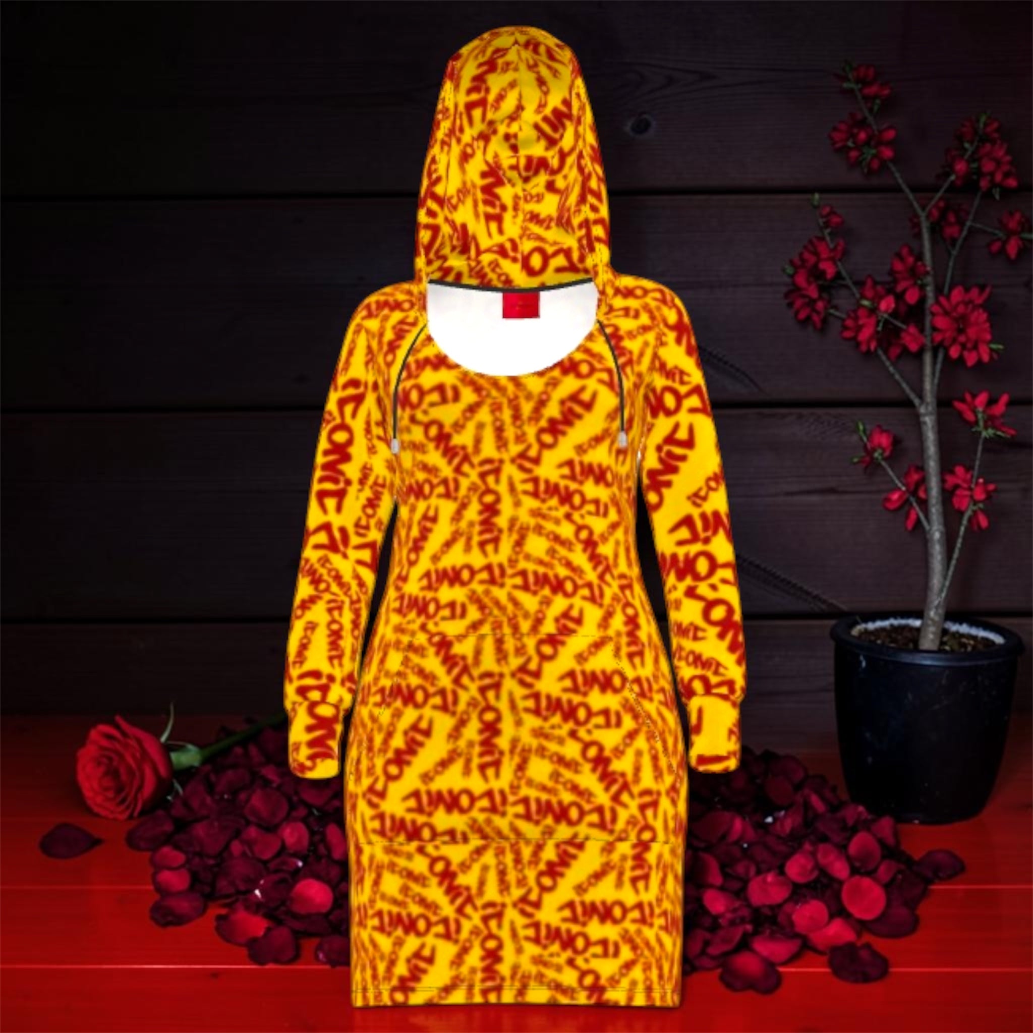 Vol IV — The ICONIC Hoodie Dress — Front view, all-over scarlet red ICONIC print on golden yellow, fitted midi silhouette with oversized hood