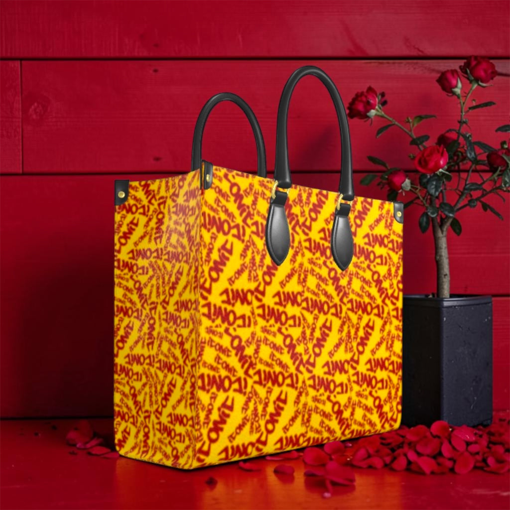 The ICONIC Statement Tote — front view, all-over ICONIC print in golden yellow and scarlet red