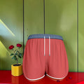 The Golden Rule Short — Scarlet red front view with navy waistband