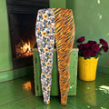 Riot Bloom Split Velour Legging front with one ditsy floral leg and one tiger-stripe leg by a fireplace