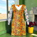 Front of cardigan dress with golden tiger-stripe body, zebra sleeve and floral sleeve