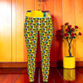 Vol II — The Lullaby Legging back view in all-over Doll Wall print on golden yellow — Golden Expression Art Eden Edit