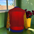 Back of The Untamed Code Jacket with red body, contrasting animal-print sleeves and royal-blue hem