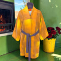 Amber Sovereign silk robe front with golden amber color-block pattern and muted purple tie belt
