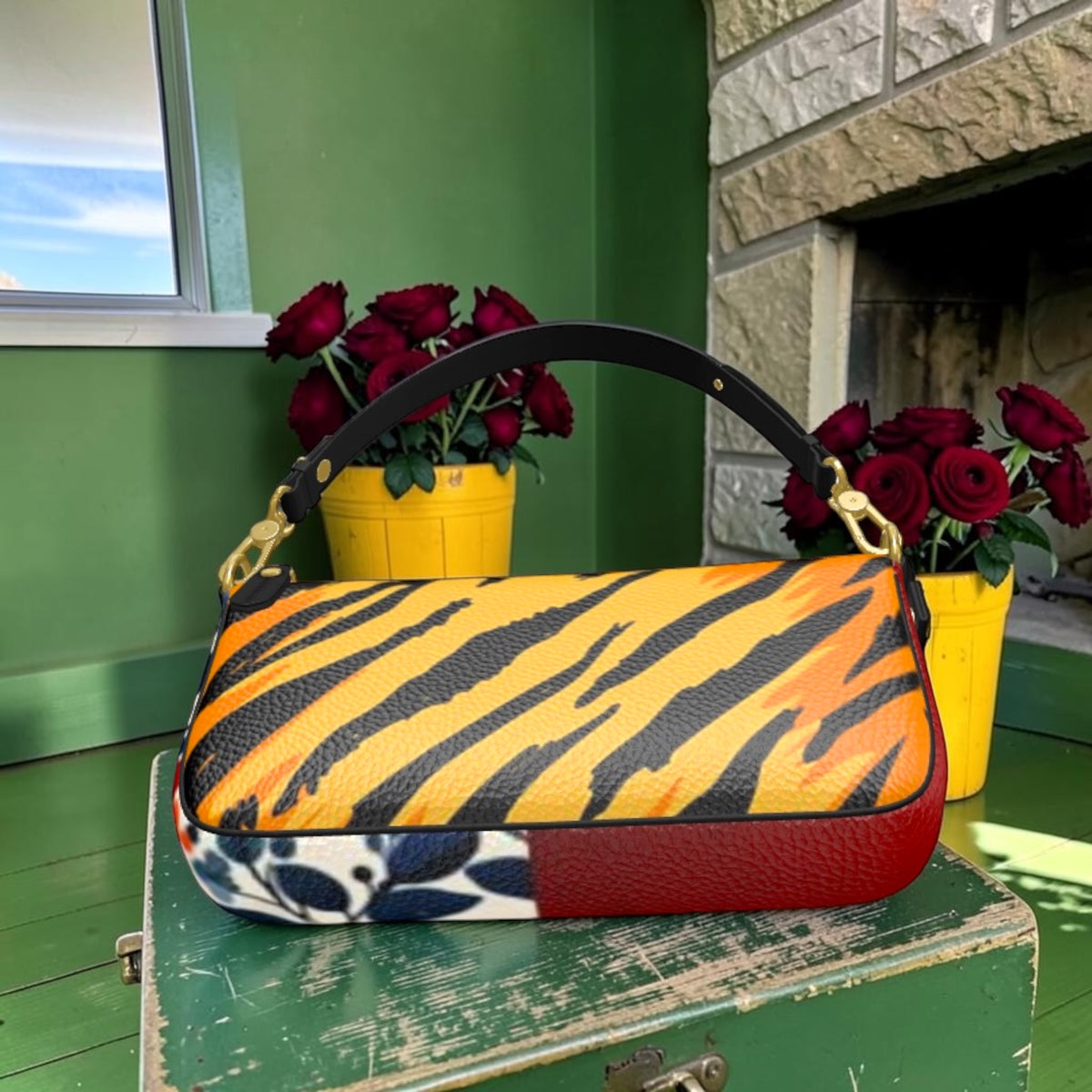 Tiger-striped textured leather shoulder bag with black strap, gold-tone hardware, floral side and red base