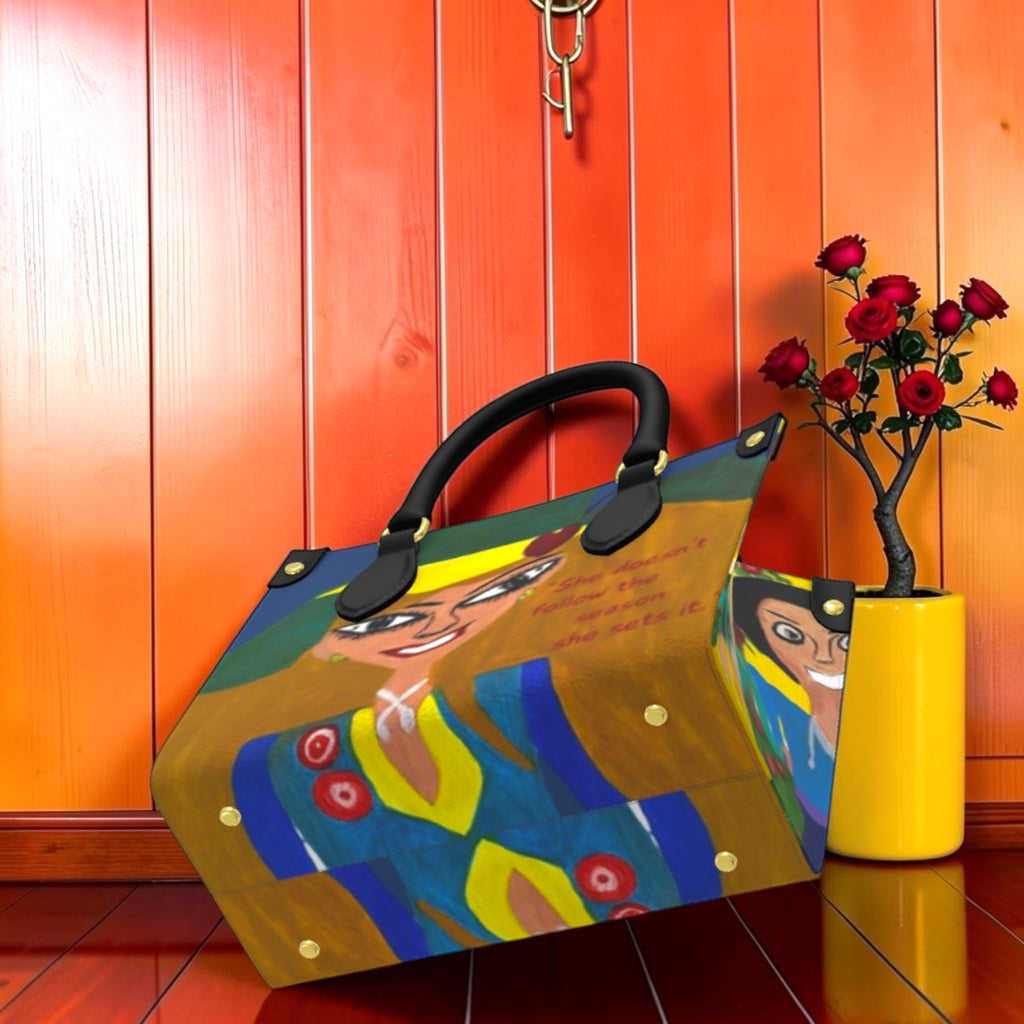 The Eden Garden Satchel — Vol II GEA — angled view showing structured mini satchel silhouette and editorial print detail