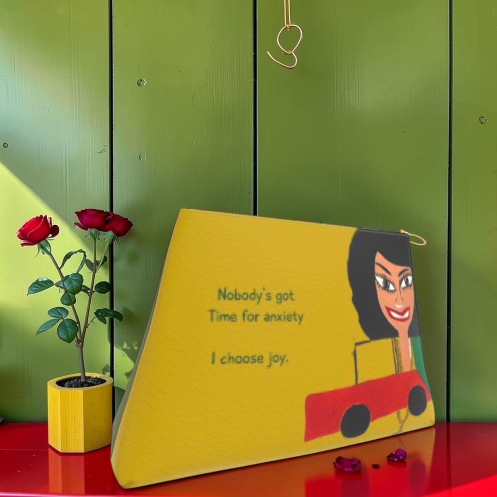 Vol I — The Joy Clutch — golden yellow front with Doll Wall figure and 'Nobody's got Time for anxiety. I choose joy.' text