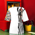 Wild Muse Oversized Tee front with portrait artwork, zebra-print panel and one floral-print sleeve on a white body.