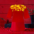 Vol IV The ICONIC Tee — front view, scarlet red tee with golden ICONIC print yoke, rose petal editorial backdrop
