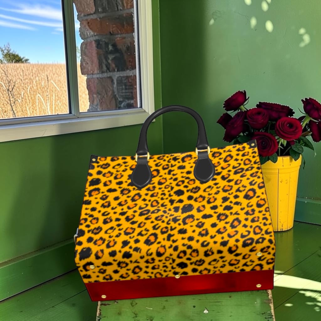 The Heat Signature Large Tote tilted to show leopard-print panel and red base with metal feet