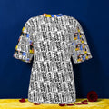 The Karma Gilles Tee front view — all-over Karma Gilles print with Doll Wall print sleeves, Golden Expression Art Vol III