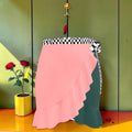 Vol I — The Cascade Rule Skirt — blush pink front panel with Checkmate DNA waistband and tie sash, forest green panel visible