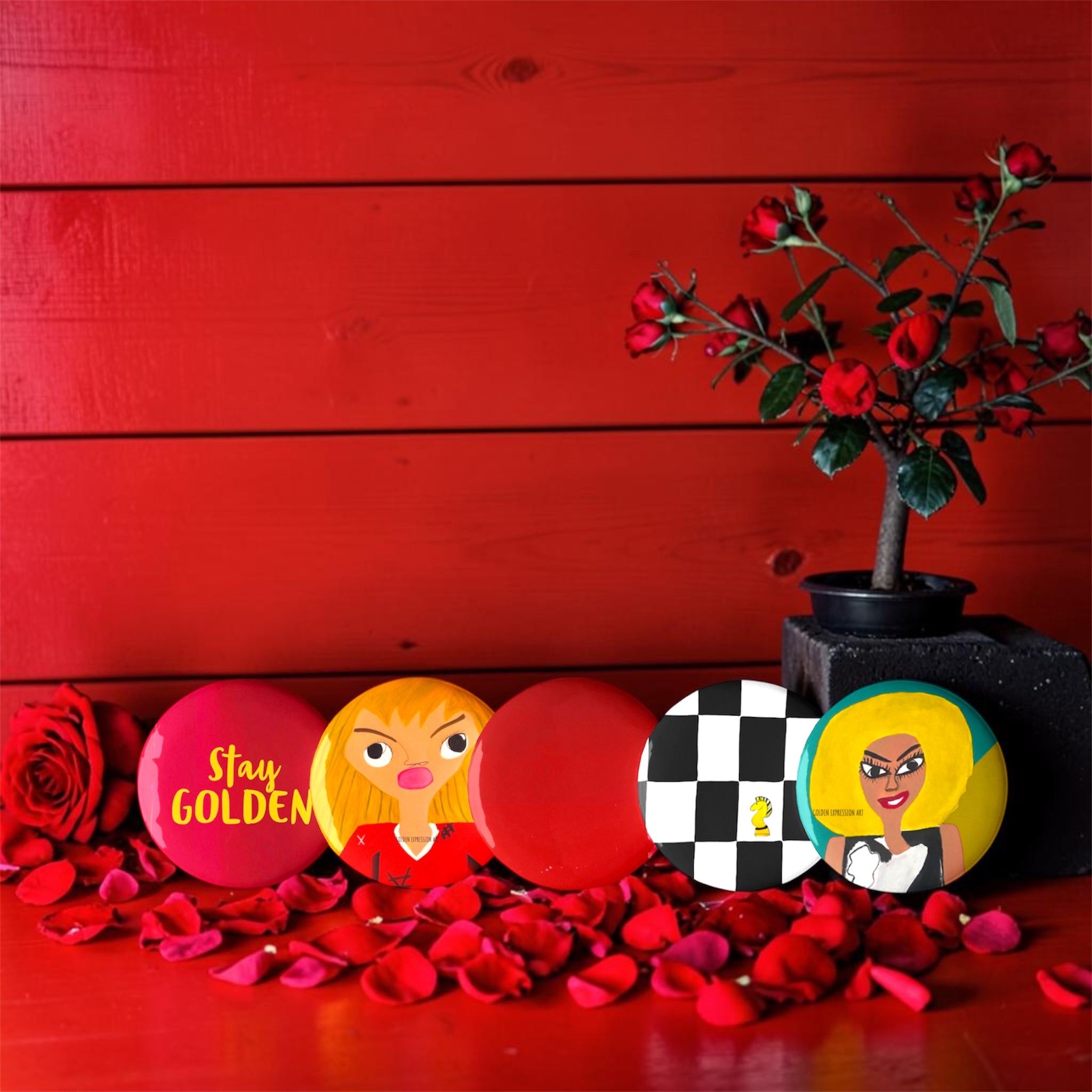 Vol IV The Golden Pins — four collector art pins on red backdrop with rose petals featuring Stay Golden, Doll Wall, Checkmate DNA, and ICONIC figures