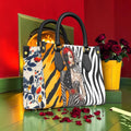 Wild Reverie Mini Satchel front with muse portrait, golden tiger stripes, zebra print and black handles