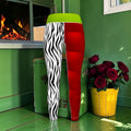 The Electric Instinct Split Legging front with one zebra-print leg, one red leg and a wide lime-green waistband.