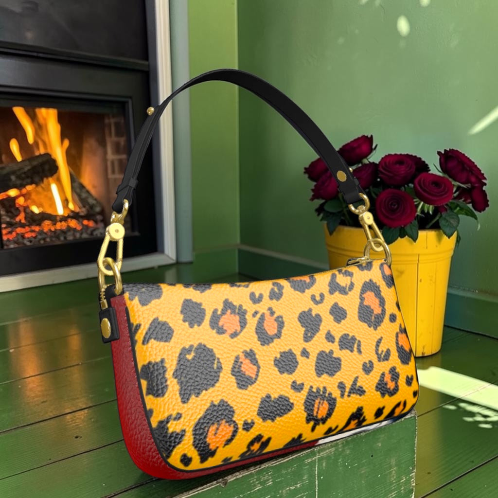 Leopard-print side of textured leather shoulder bag with red side panel and gold-tone hardware