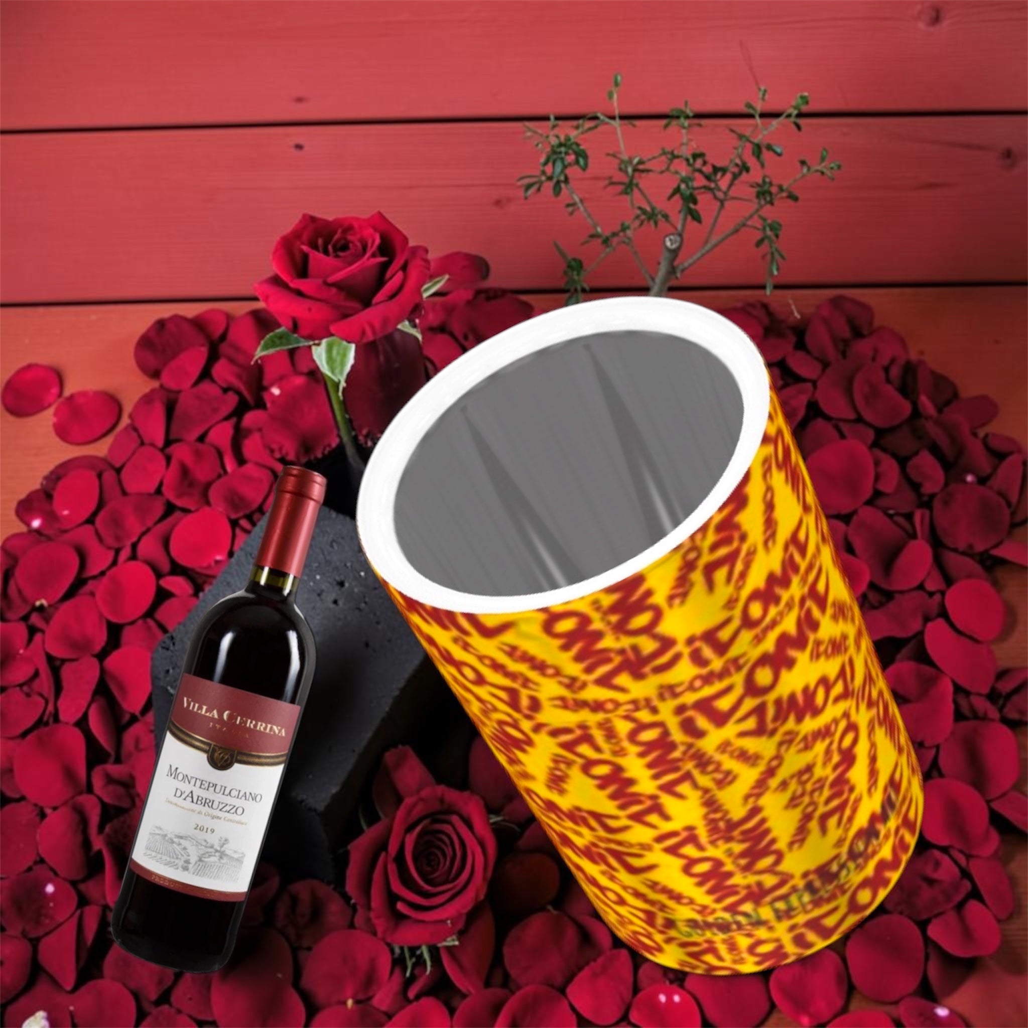 The ICONIC Mist Wine Cooler — golden yellow ICONIC all-over print with scarlet red lettering, styled with red roses and wine bottle