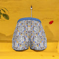 Front view of The Gallery Code Short featuring a Checkmate and Doll Wall collage print with a cerulean blue drawstring waistband