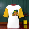 Vol II — The Eden Venture Tee, front view, white color-block body with golden yellow sleeves, burgundy collar, Doll Wall lady graphic with I Decide My Own Attitude text, GEA branding — Golden Expression Art