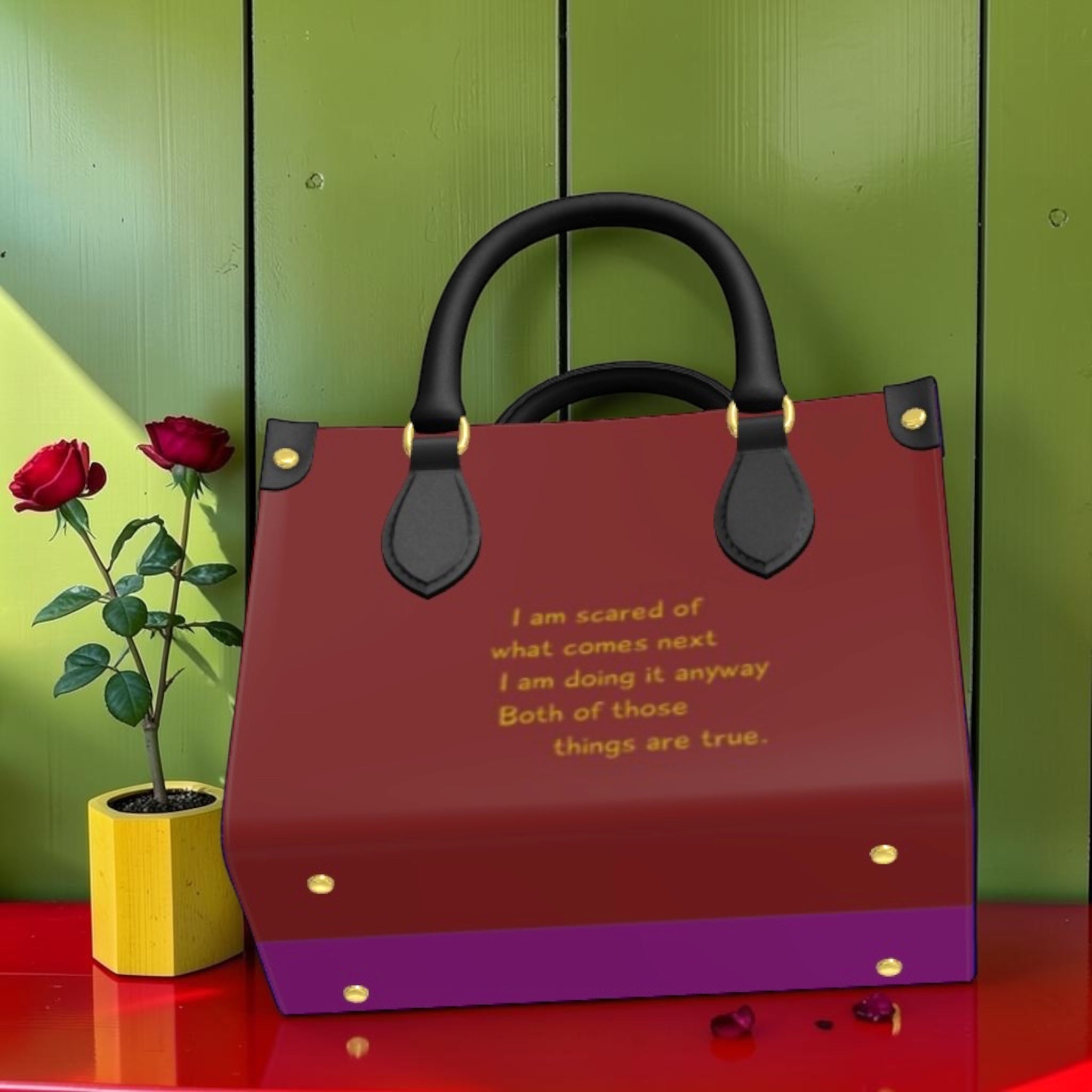 Vol I — The Doll Wall Lady Bag, back view, deep burgundy body, purple base panel, gold quote text detail, black handles, gold stud hardware, GEA
