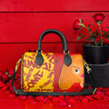 The ICONIC Venture Mini Duffel — ICONIC all-over print on golden yellow with Doll Wall scarlet red panel, black handles, gold hardware