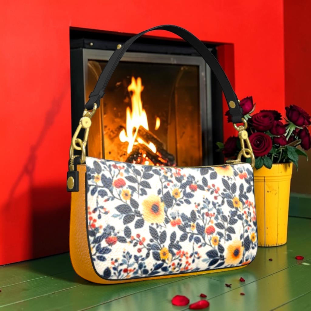 Floral side of The Leopard Muse Shoulder Bag with yellow and red flowers, dark foliage and golden-amber trim.