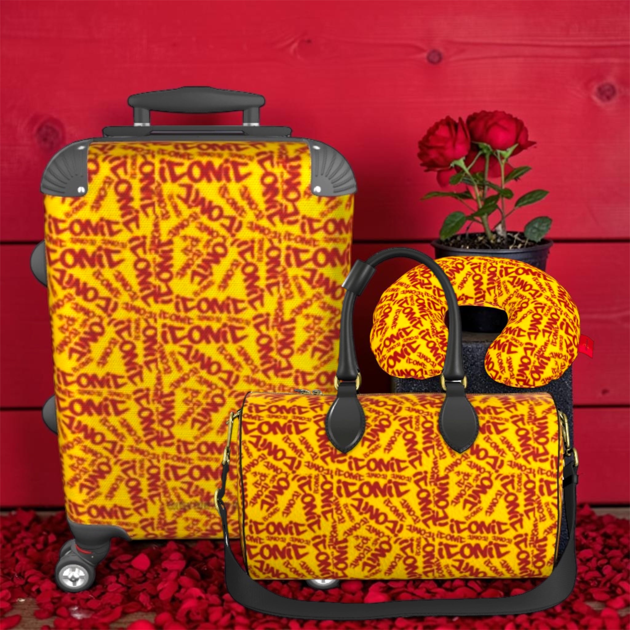 The ICONIC Getaway carry-on styled with The ICONIC Carry duffel and ICONIC neck pillow — full travel set, golden yellow ICONIC print, rose petal backdrop