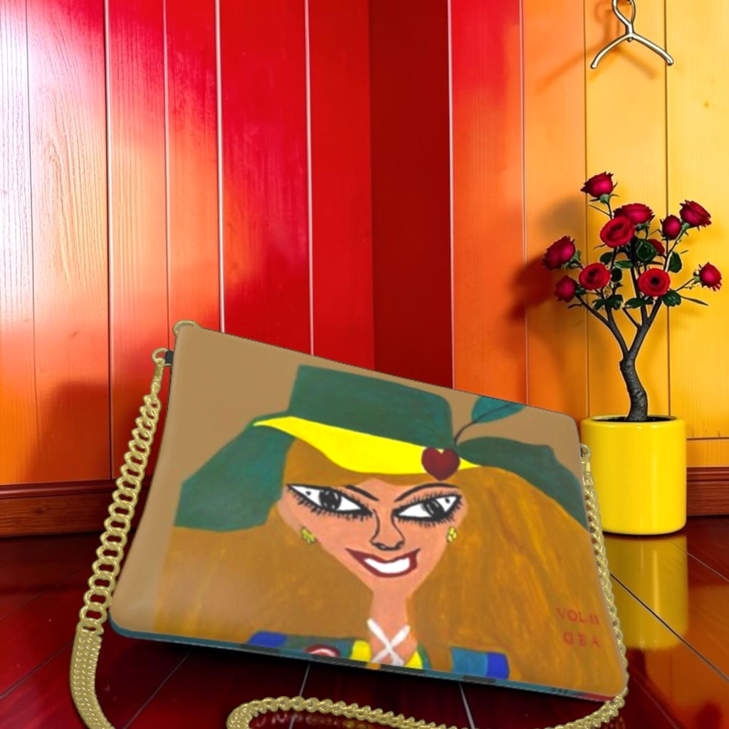 Vol II The Eden Secret Clutch — front view, Doll Wall figure on tan body with gold chain strap, GEA Vol II editorial