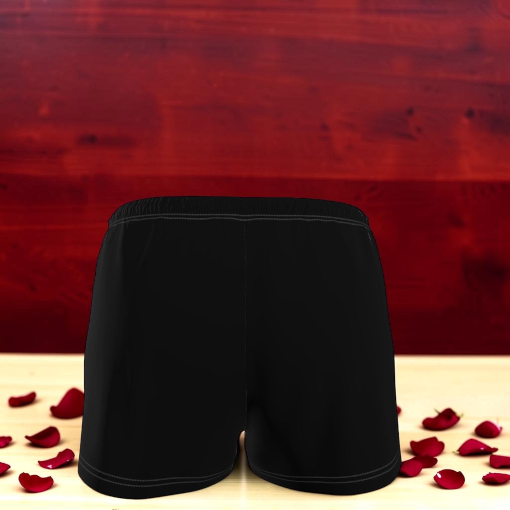 The Eclipse Short — solid black reverse, athletic short back view, rose petal backdrop, Vol III Night Time Edit by Golden Expression Art
