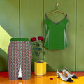 The ICONIC Butterfly Shirt — set styling with ICONIC skirt, green wall editorial