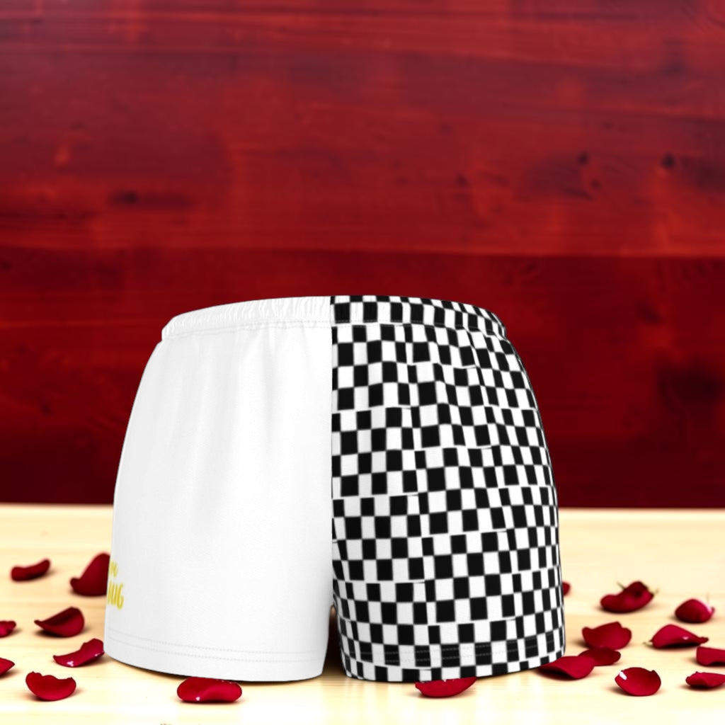 The Eclipse Short — white and black checkered color-block athletic short, front view, rose petal backdrop, Vol III Night Time Edit by Golden Expression Art